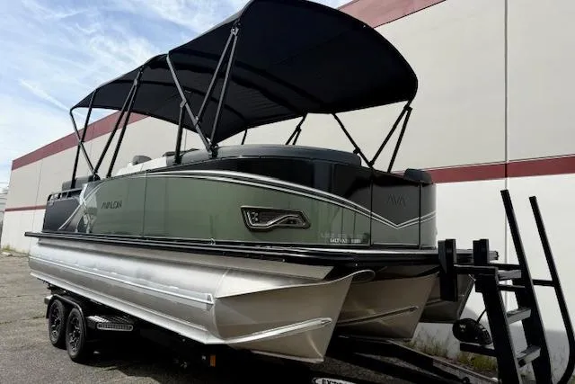 Slide: The Image of 2026 Avalon LSZ Quad Lounge Shift pontoon boat on trailer, featuring sleek design and canopy. - 29