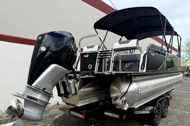 Slide: The Image of 2026 Avalon LSZ Quad Lounge Shift pontoon boat with outboard motor and canopy. - 30