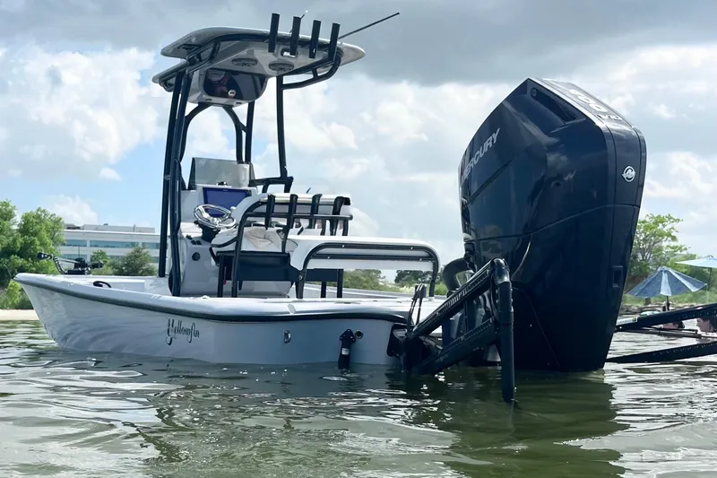 Slide: The Image of 2025 Yellowfin 24 Bay CE boat with Mercury engine on calm water. - 3