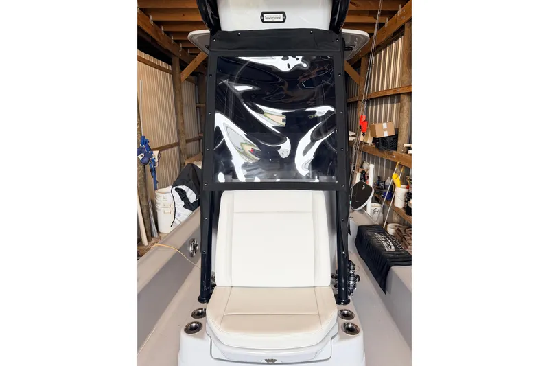 Slide: The Image of 2025 Yellowfin 24 Bay CE boat interior with white seating and protective cover. - 7