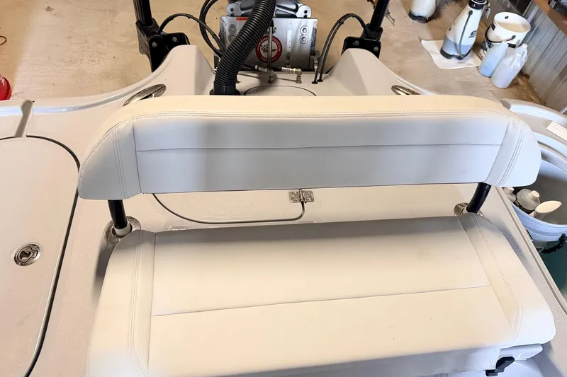 Slide: The Image of 2025 Yellowfin 24 Bay CE boat seat with white upholstery and storage compartment. - 9