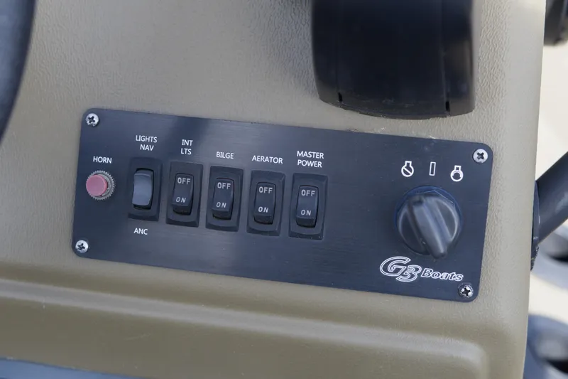 Slide: The Image of Control panel of 2023 G3 Gator Tough 18 CC boat with switches and knobs. - 12