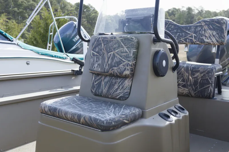 Slide: The Image of 2023 G3 Gator Tough 18 CC boat interior with camo seating and console. - 4