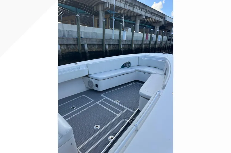 Slide: The Image of 2012 Contender 35 LS boat interior with cushioned seating and sleek flooring. - 6