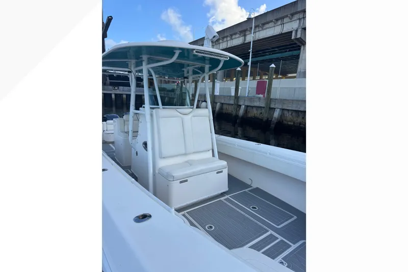 Slide: The Image of 2012 Contender 35 LS boat with seating and T-top at a dock. - 7