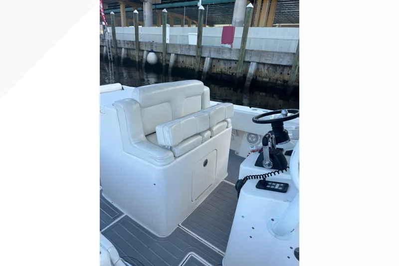 Slide: The Image of 2012 Contender 35 LS boat interior with white seating and steering console. - 8