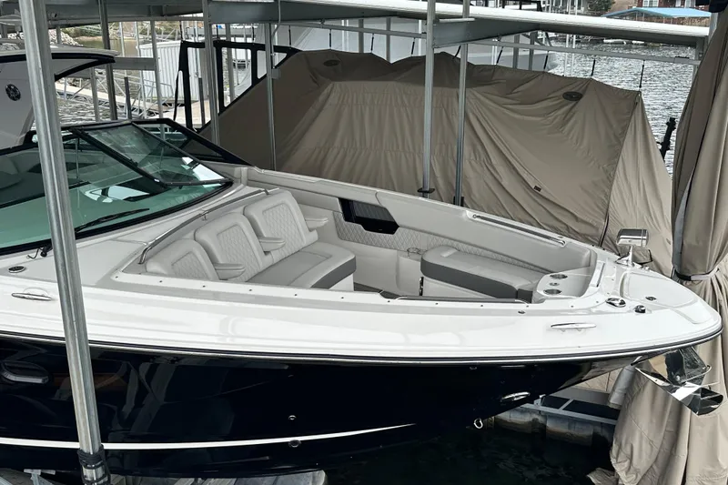 Slide: The Image of 2023 Sea Ray SLX 400 boat docked, featuring sleek design and spacious seating. - 11