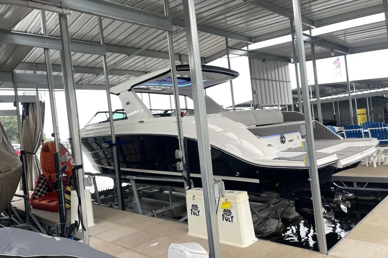 Slide: The Image of 2023 Sea Ray SLX 400 boat docked in a covered marina. - 12