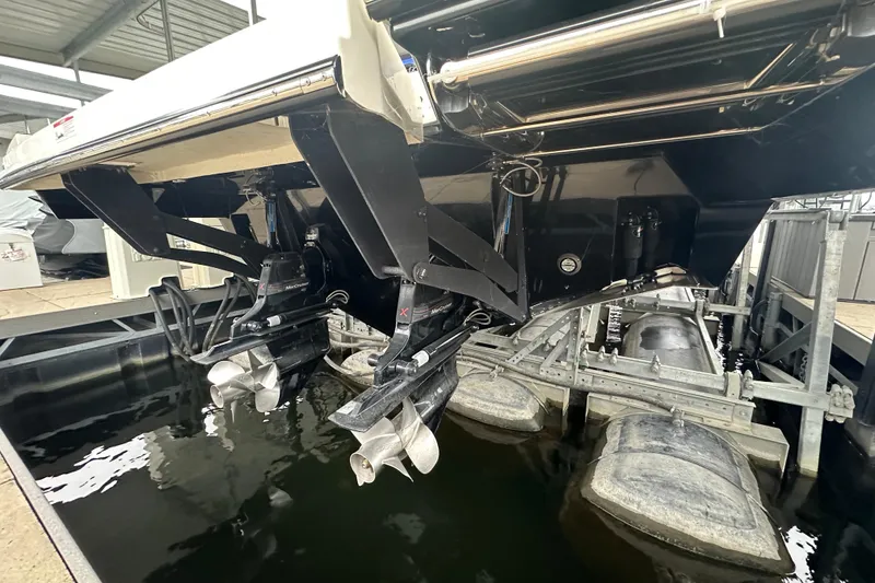 Slide: The Image of 2023 Sea Ray SLX 400 boat with dual propellers in a marina setting. - 19