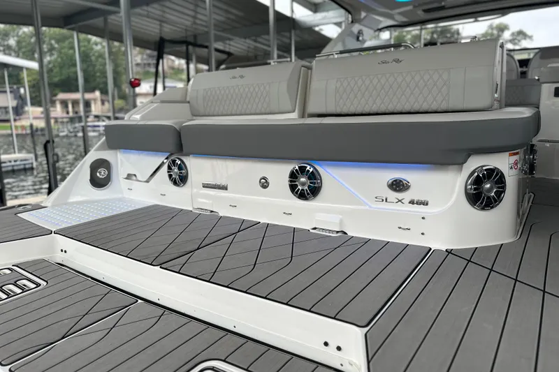 Slide: The Image of 2023 Sea Ray SLX 400 boat interior with cushioned seating and modern design. - 23