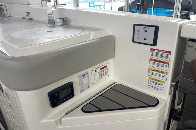 Slide: The Image of 2023 Sea Ray SLX 400 boat interior with control panel and safety warnings. - 26