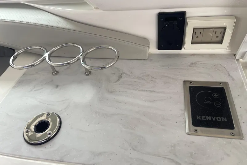 Slide: The Image of 2023 Sea Ray SLX 400 boat interior with Kenyon control panel and cup holders. - 28
