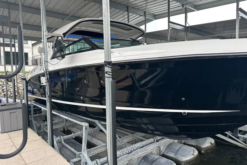 Slide: The Image of 2023 Sea Ray SLX 400 boat docked in a covered marina. - 3