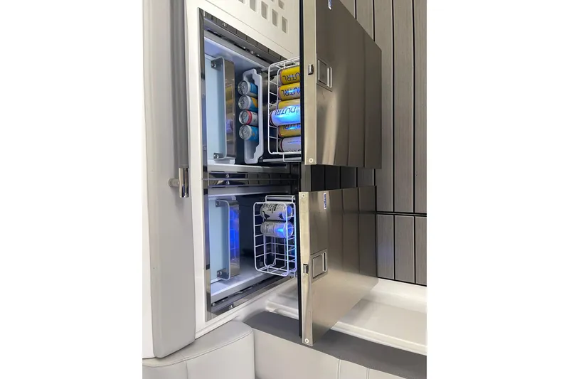 Slide: The Image of Stainless steel refrigerator on 2023 Sea Ray SLX 400 yacht, stocked with beverages. - 30