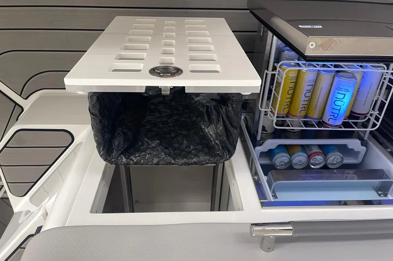 Slide: The Image of 2023 Sea Ray SLX 400 boat interior with beverage cooler and storage compartment. - 32