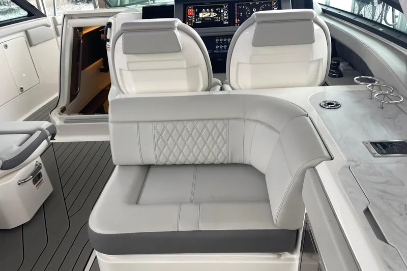 Slide: The Image of Interior of 2023 Sea Ray SLX 400 boat with luxurious seating and modern dashboard. - 33