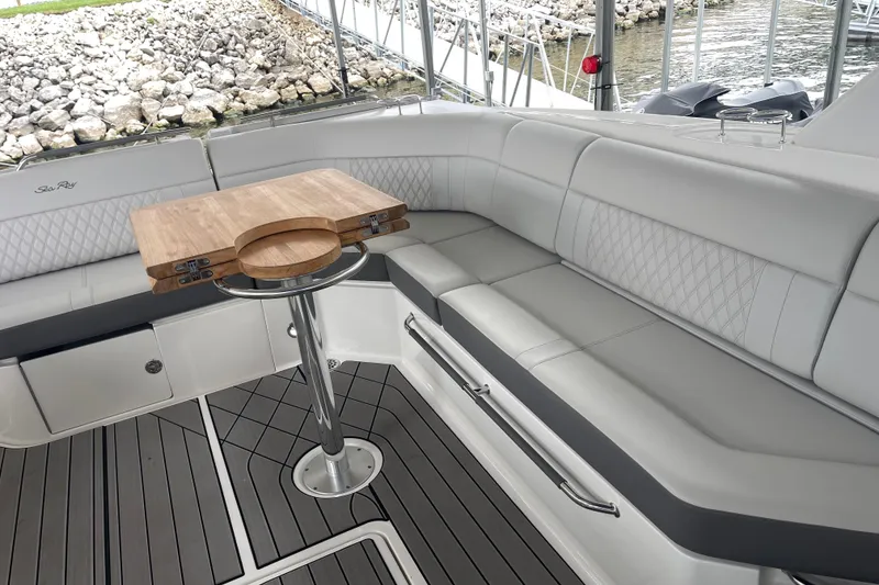Slide: The Image of 2023 Sea Ray SLX 400 boat interior with elegant seating and wooden table. - 34