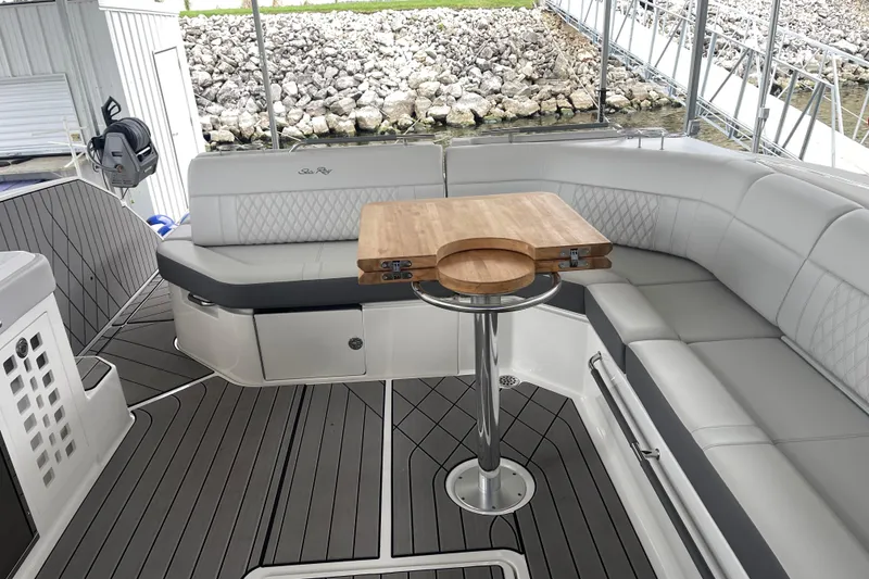 Slide: The Image of Luxurious seating area on 2023 Sea Ray SLX 400 boat with wooden table and elegant design. - 35