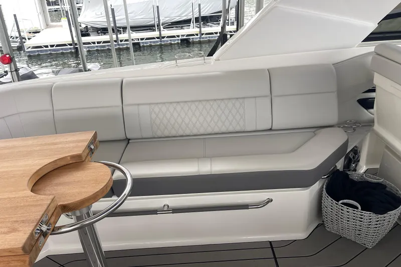 Slide: The Image of Luxurious seating area on 2023 Sea Ray SLX 400 yacht with wooden table. - 36