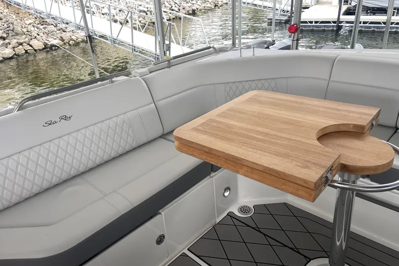 Slide: The Image of Luxurious seating and wooden table on 2023 Sea Ray SLX 400 boat deck. - 37