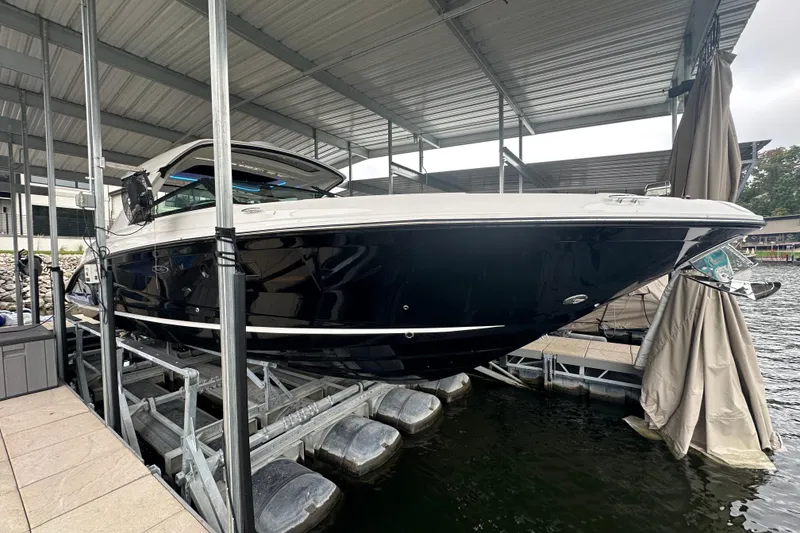 Slide: The Image of 2023 Sea Ray SLX 400 boat docked under a covered marina. - 4