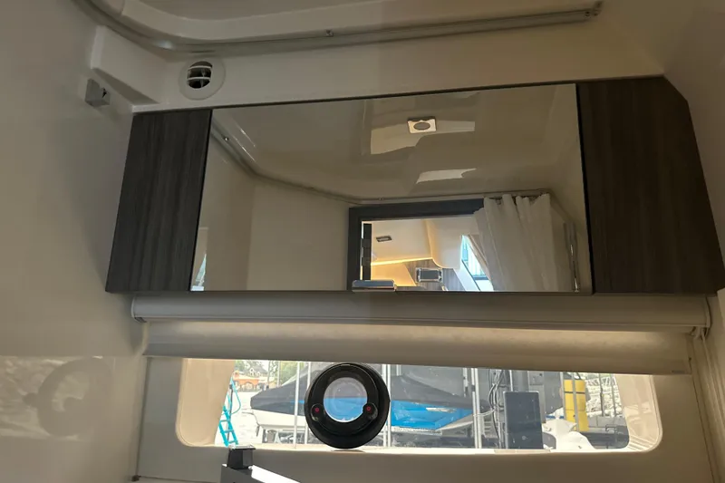 Slide: The Image of Interior of 2023 Sea Ray SLX 400 yacht with modern cabinetry and window view. - 44