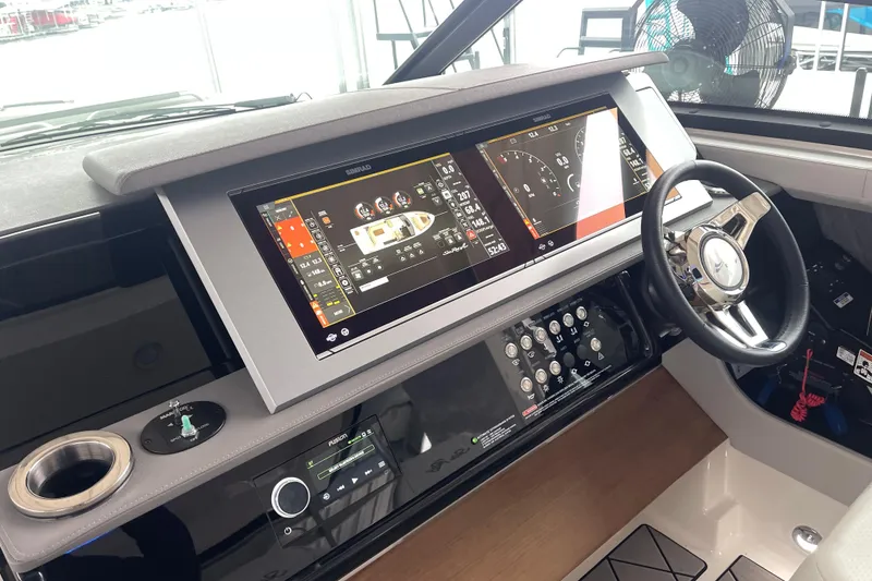 Slide: The Image of 2023 Sea Ray SLX 400 helm with advanced navigation displays and controls. - 45
