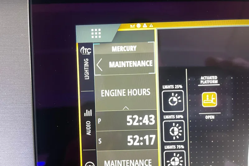 Slide: The Image of Dashboard display of a 2023 Sea Ray SLX 400 showing engine hours and lighting controls. - 46