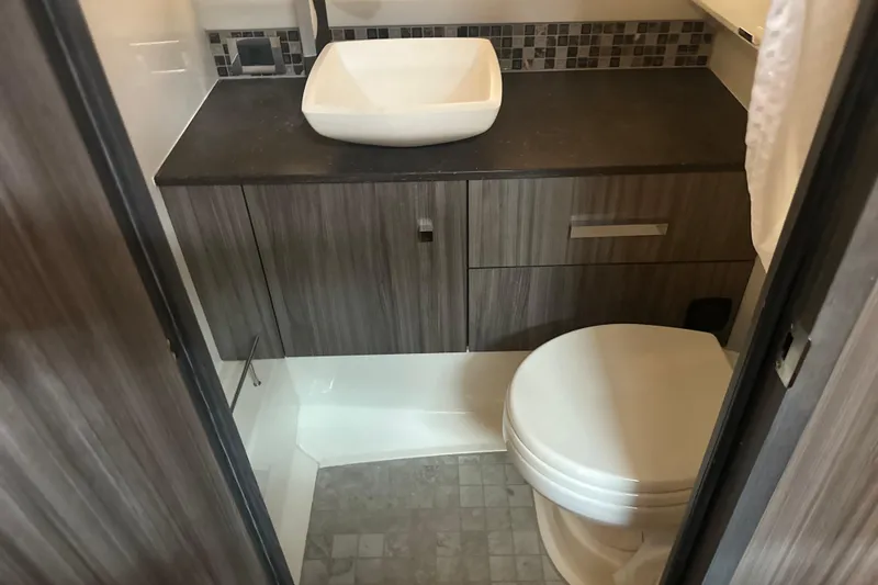 Slide: The Image of Modern bathroom interior of 2023 Sea Ray SLX 400 yacht, featuring sleek design and fixtures. - 47