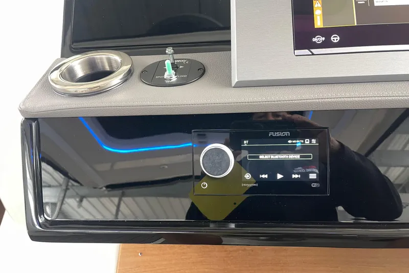 Slide: The Image of Control panel of 2023 Sea Ray SLX 400 boat with Fusion audio system. - 48