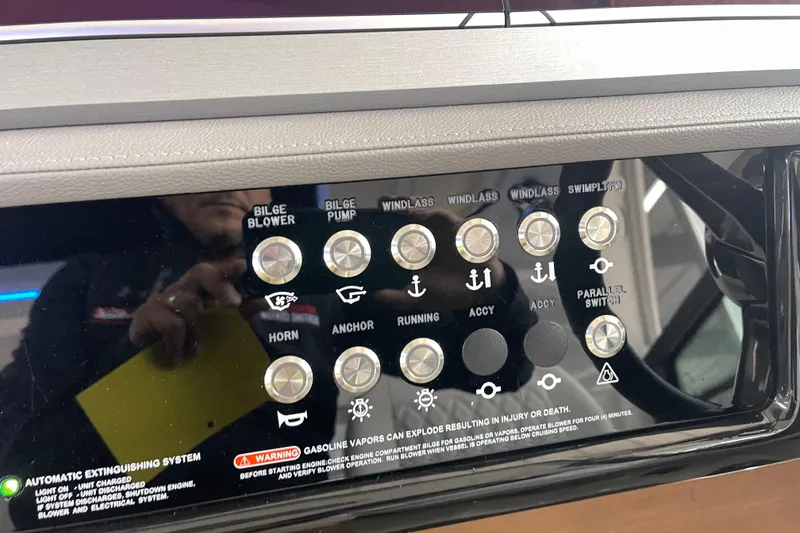 Slide: The Image of Control panel of 2023 Sea Ray SLX 400 boat with labeled buttons and switches. - 49