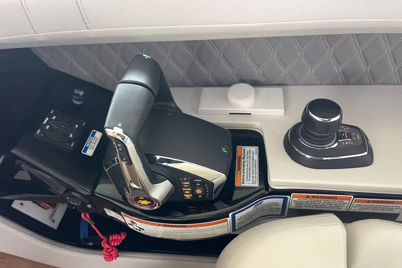 Slide: The Image of 2023 Sea Ray SLX 400 boat controls with joystick and throttle lever. - 51