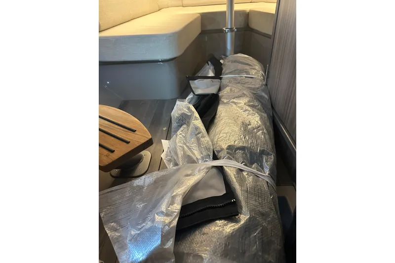 Slide: The Image of Interior of 2023 Sea Ray SLX 400 boat with wrapped equipment on the floor. - 55