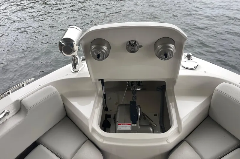 Slide: The Image of 2023 Sea Ray SLX 400 boat anchor compartment with seating, on calm water. - 57