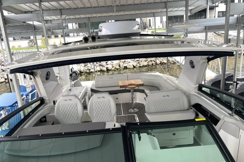 Slide: The Image of 2023 Sea Ray SLX 400 luxury boat interior with elegant seating and table. - 59