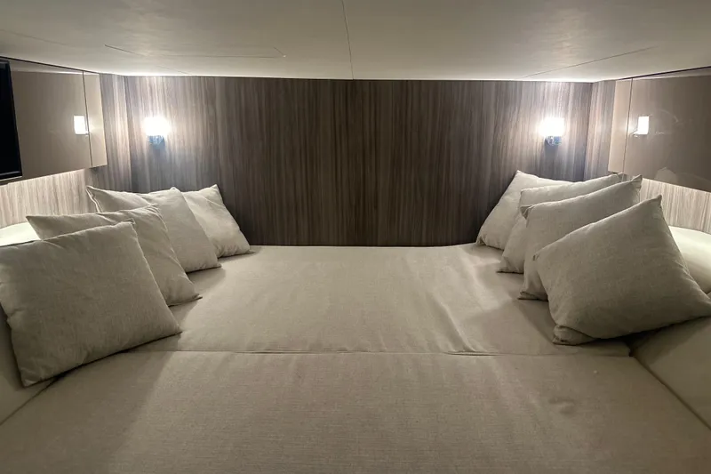 Slide: The Image of Luxurious cabin interior of 2023 Sea Ray SLX 400 with plush bedding and ambient lighting. - 63