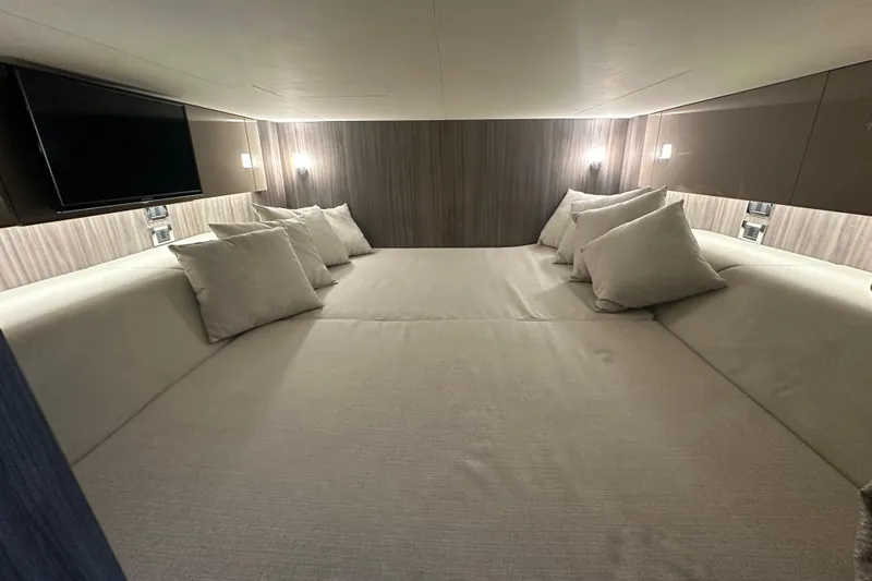 Slide: The Image of Luxurious cabin interior of 2023 Sea Ray SLX 400 yacht with cozy bedding and ambient lighting. - 64