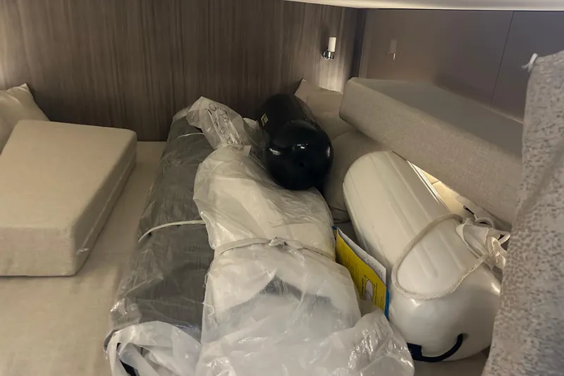 Slide: The Image of Interior cabin of 2023 Sea Ray SLX 400 with stored boating equipment. - 67