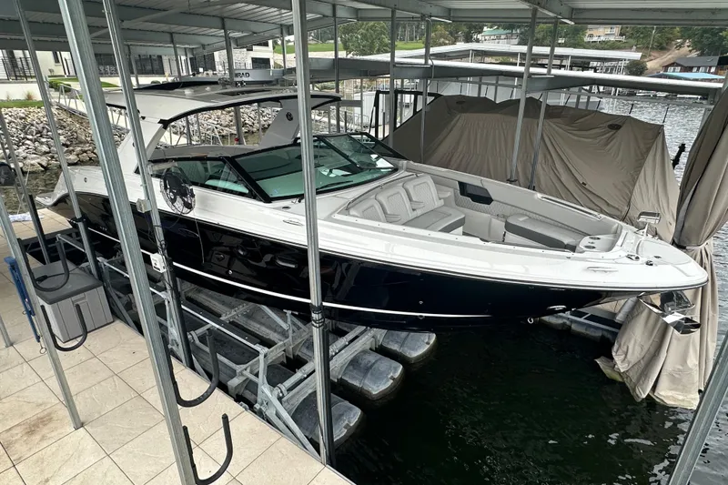 Slide: The Image of 2023 Sea Ray SLX 400 boat docked in a marina, featuring sleek design and spacious seating. - 7