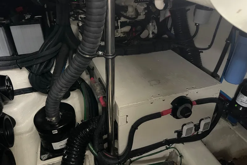 Slide: The Image of Engine compartment of a 2023 Sea Ray SLX 400 boat, showcasing mechanical components and wiring. - 78