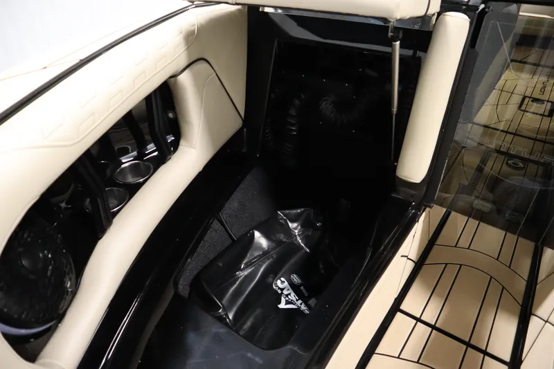 Slide: The Image of 2024 Centurion Ri230 boat in a showroom, featuring sleek black and gold design. - 12