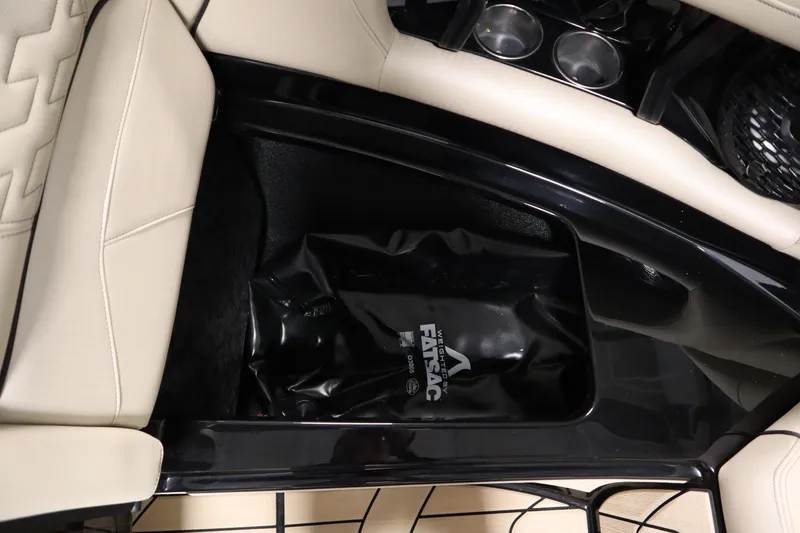 Slide: The Image of 2024 Centurion Ri230 boat with beige interior in a spacious garage. - 14