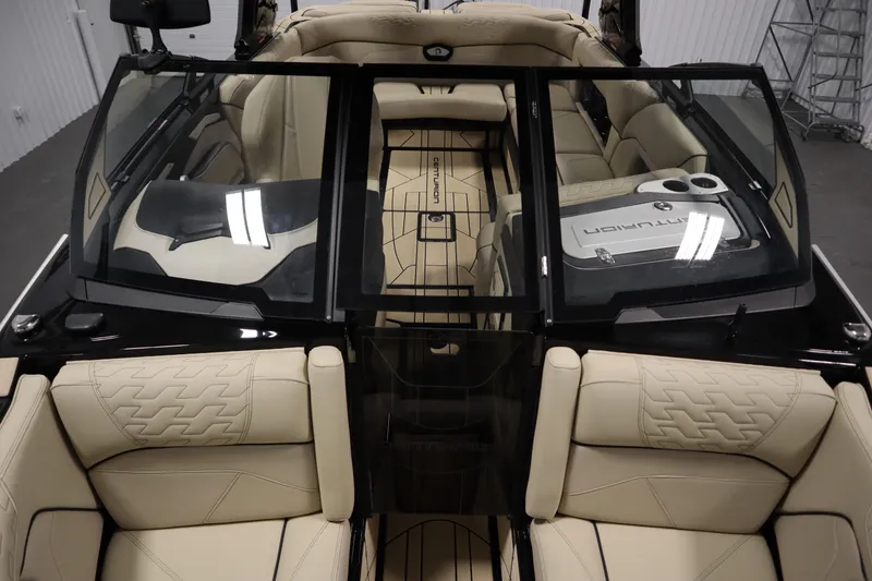 Slide: The Image of 2024 Centurion Ri230 interior with beige seating and black storage compartment. - 17