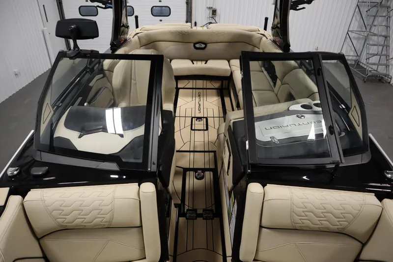 Slide: The Image of 2024 Centurion Ri230 boat interior with beige seating and black flooring. - 18