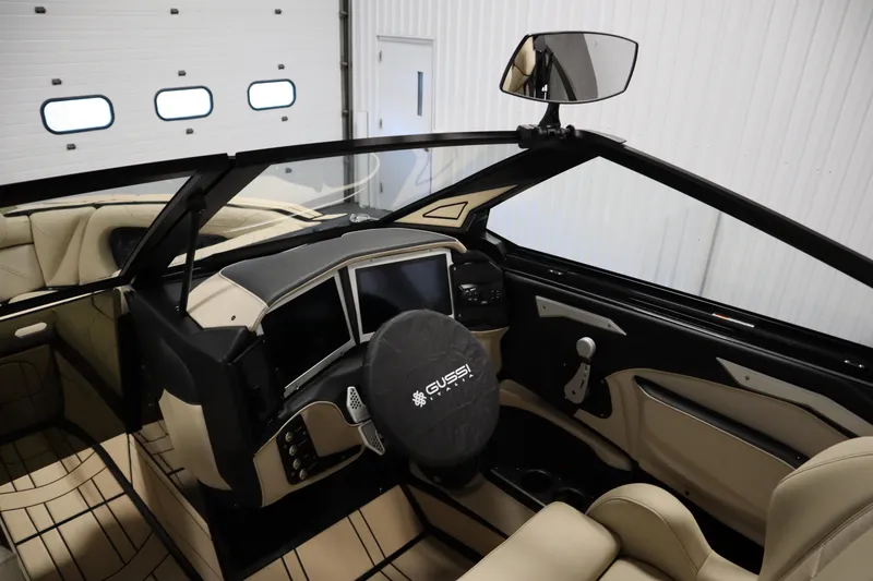 Slide: The Image of 2024 Centurion Ri230 boat interior with beige seating and sleek design. - 19