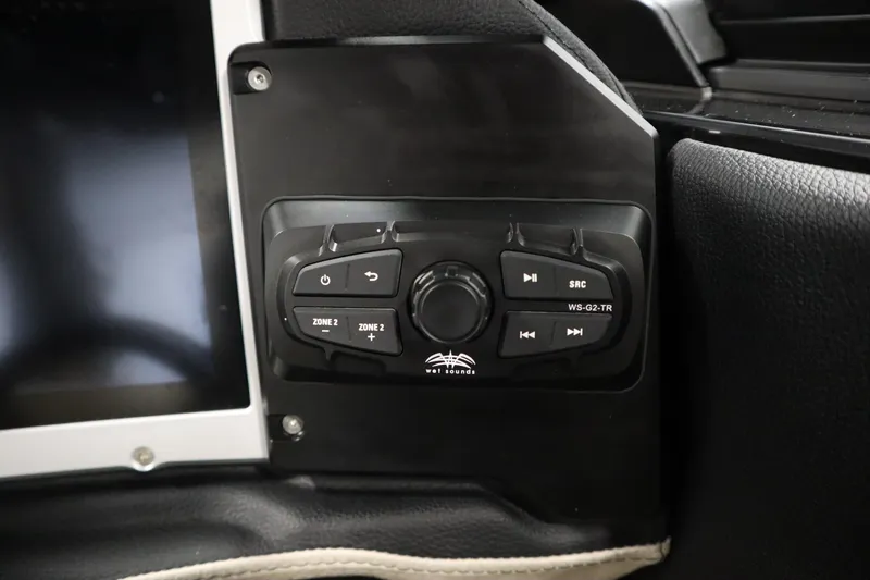 Slide: The Image of Steering wheel of 2024 Centurion Ri230 boat with modern dashboard controls. - 27