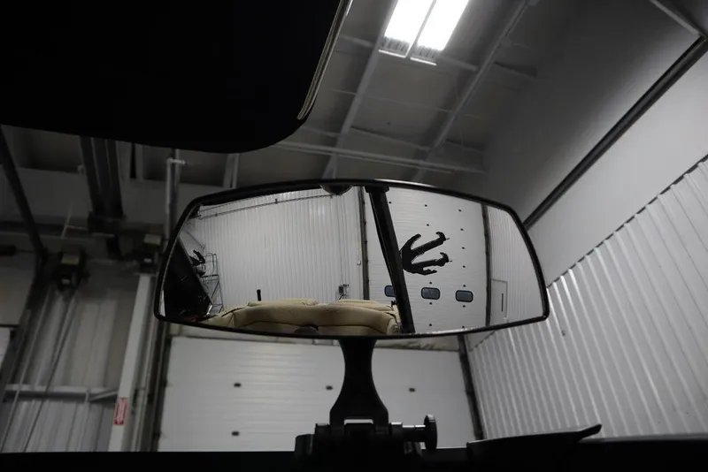 Slide: The Image of 2024 Centurion Ri230 rearview mirror reflecting a garage interior with overhead lights. - 38