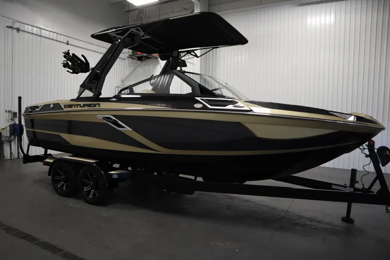 Slide: The Image of 2024 Centurion Ri230 boat on trailer in showroom setting. - 4