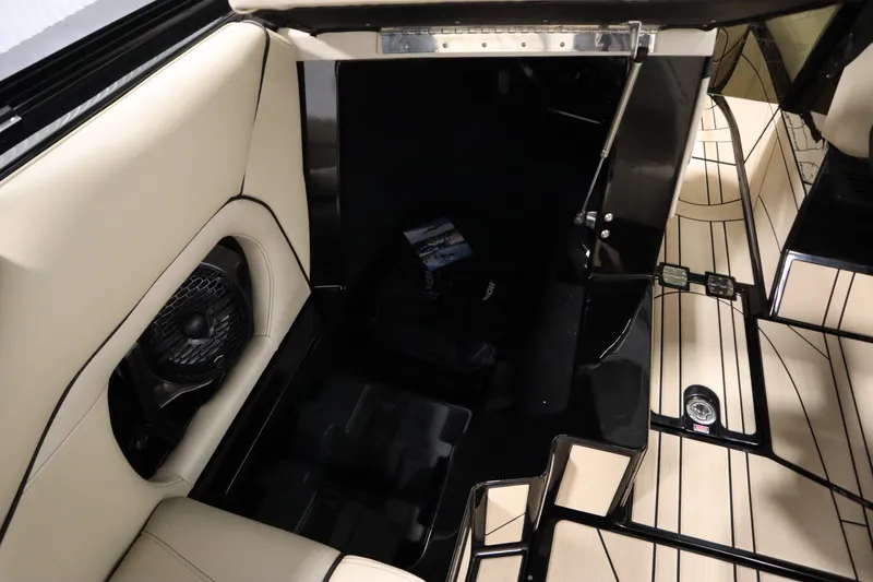 Slide: The Image of 2024 Centurion Ri230 storage compartment with open door and warning labels. - 43