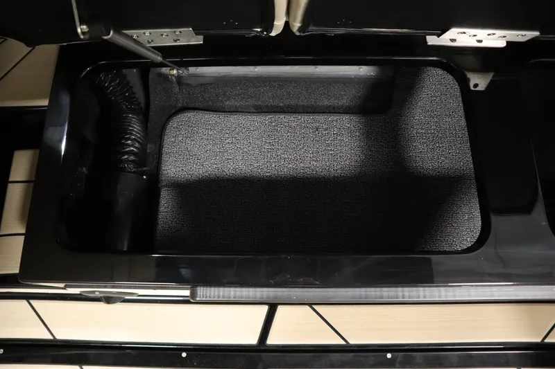 Slide: The Image of Interior of 2024 Centurion Ri230 boat, featuring beige seating and black accents. - 48